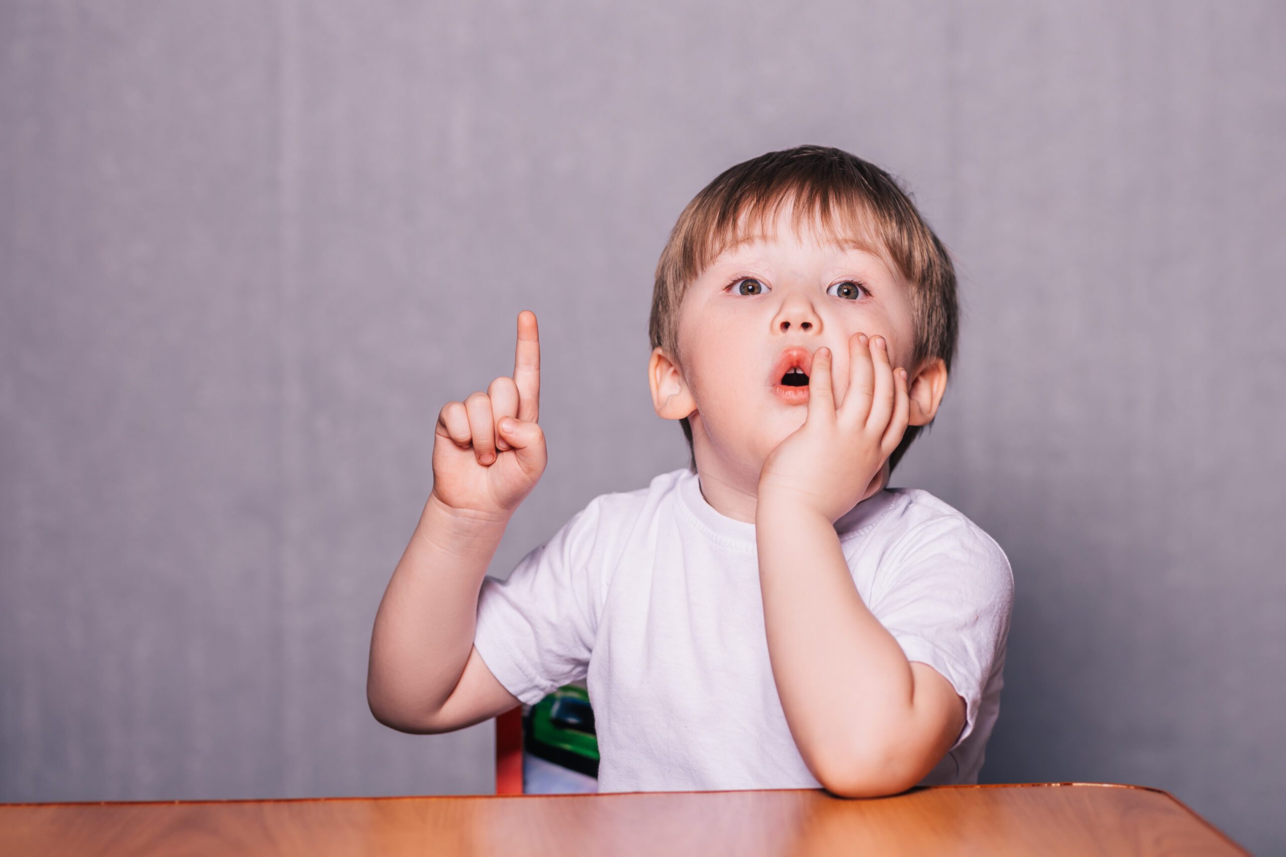Little boy sitting on chair at the table